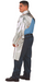 Man wearing Chicago Protective Apparel 564-APBI-40 Open Back 7 oz Aluminized PBI Blend Heat Resistive Coat on white background