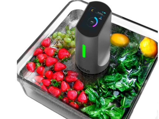 Black and silver Mira Safety DTX-1 Food Detoxifier in a dish of multi color vegetables on white background